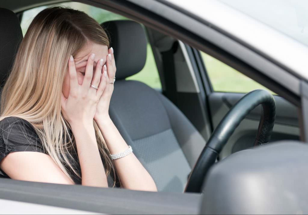 Girl anxious behind the wheel of a car