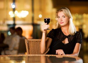 Woman holding up a glass of wine